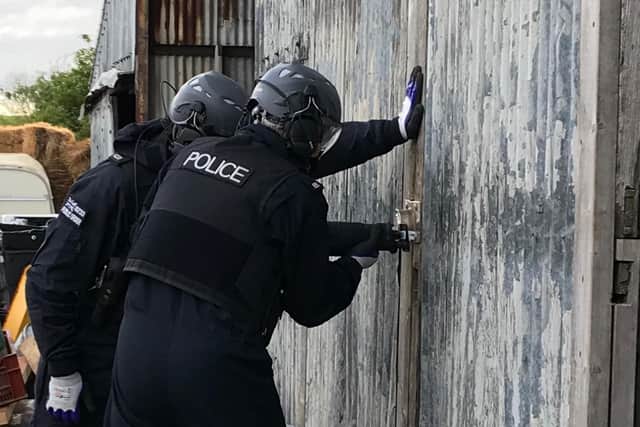 Thames Valley Police officers executing a warrant as part of an operation targeting organised crime and drug supply across the policing area, including Banbury (Image from TVP website)