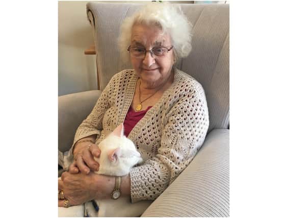 Highmarket House Care Home in Banbury is hosting a cat show for the community - pictured is resident Joan and Ned, the lifestyle coordinator's cat and regular visitor (Submitted photo from the care home)