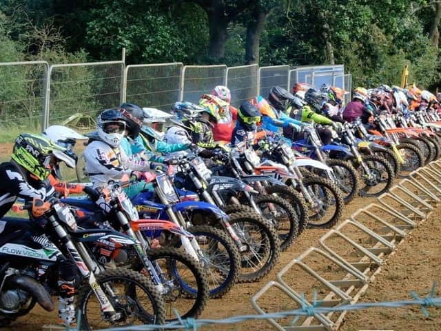 Motocross competitors line up at the start of a race at Wroxton