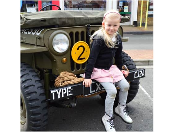Darcie Embra-Barnes enjoys a seat on one of the exhibition jeeps. (Image from the Banbury Town Council)