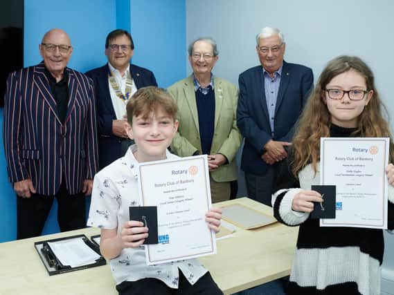 Finn Tibbetts and Hollie Hughes are pictured with their prizes. Also pictured are, from left to right, Harry Rhodes, David Richardson the Rotary President and Rotarians Tim Bryce and Ashley Bedding