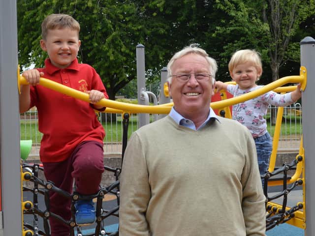 Ollie Buckle, aged three, and his sister Becky, two, watched the playground take shape and tried out the climbing frame at the opening by Cllr John Colegrave (pictured)