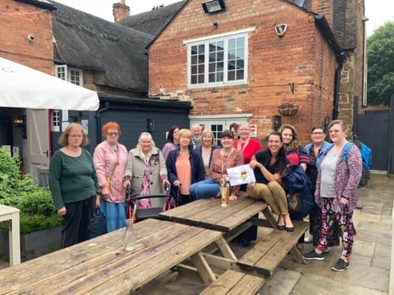 Members of the Monday Meet-up group at The Pigeons Inn pub pose for a photo with the pub's owner - Tina Laird - and meet-up scheme coordinator Lara McDonagh.