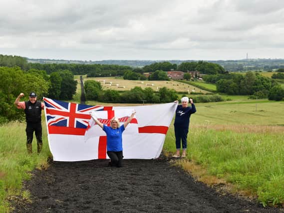 Team members of two local racehorse training teams (Paul Webber Racing & DAB Racing)held up flags at the top of the gallop at Cropredy Lawn showing their support for Englandahead of their EURO semi-final game (photo credit to Martin Archer)
