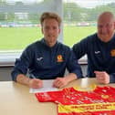 Morgan Roberts signs for Banbury United with manager Andy Whing (Picture courtesy of Banbury United)