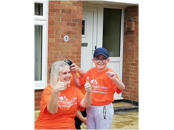Rachel Jarrett, from Middleton Cheney, has raised £295 for Helen & Douglas House, by having her hair shaved off by Nathan, aged 9, who is cared for by the children’s hospice. (submitted photo)
