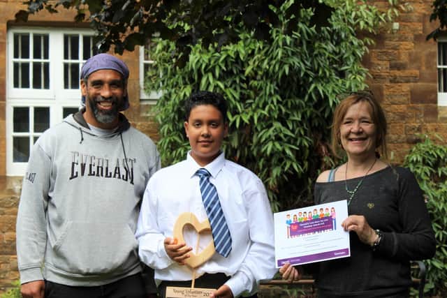 Adidja Carpenter, aged 11, the Young Volunteer of the Year winner, received his award from Selma Wakeman and is pictured with Dave Earl (Submitted photo from Sanctuary)
