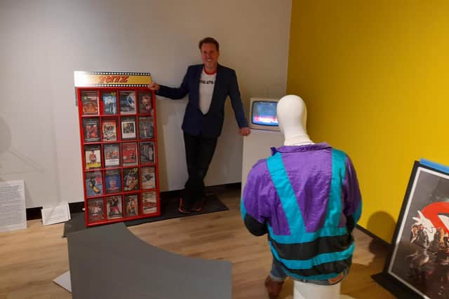 Pictured: Matt Fox - the curator for the 'I Grew Up in the 80s' exhibit - is pictured with Wayne the mannequin who is display some 80s fashion clothes