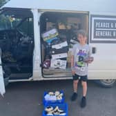 Joshua Wilson, 11, at Silverstone with his parents' van filled with surplus food from the British Grand Prix