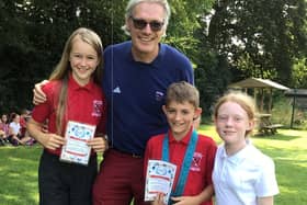 Olympic rowing gold medallist Tim Foster MBE pupils Daisy, Samuel and Evie at Deddington CE Primary School end of year outdoor celebration assembly