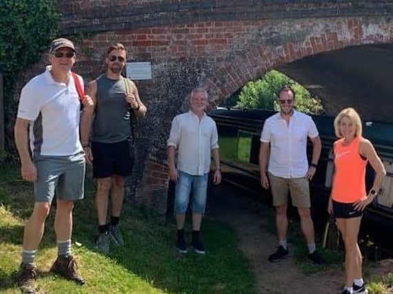 Castle Quay management staff enjoy a hot walk along the canalside for charity