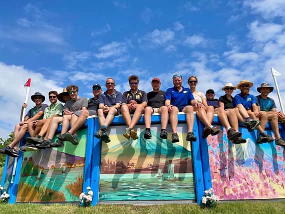 The photo shows the course building team in Tokyo on top of one Nigel Fletcher's paintings, including his son Carl shown sixth from the right.