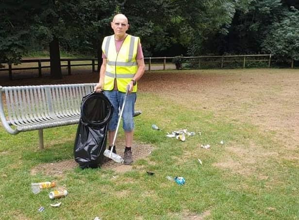 David Clare of Banbury Litter Pickers collects rubbish in a Banbury park