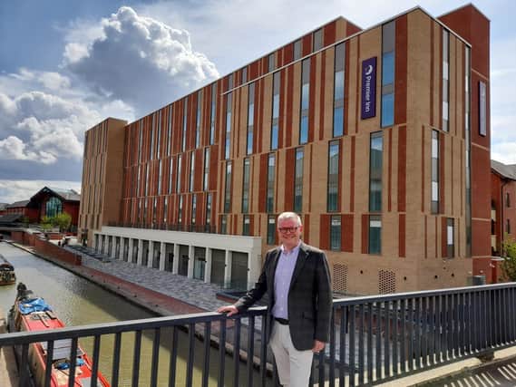 Cllr Ian Corkin, deputy leader of Cherwell District Council, stands in front of the new Premier Inn hotel set to open next week in the town centre of Banbury