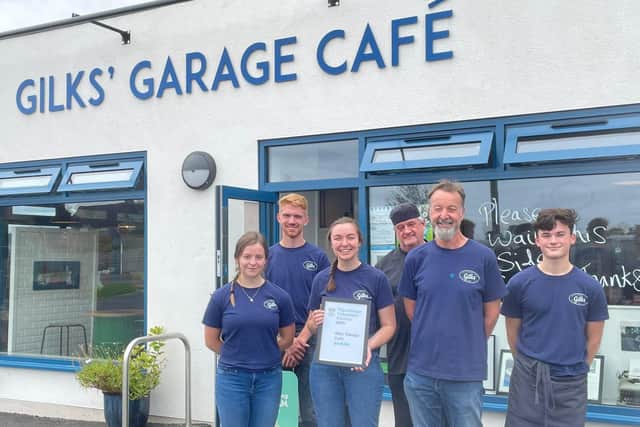 Staff at Gilks' Garage Café in Kineton hold up their award