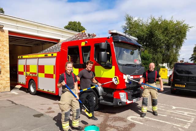 Banbury firefighters (from left) Kim Lapington, Charlie Mawle and Russell Parker prepare to wash a fire appliance at the Banbury Fire Station. They will a charity car wash on Saturday August 28.