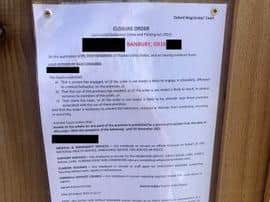 Working on the notice that confirms partial closure of a Banbury house where arrests were made