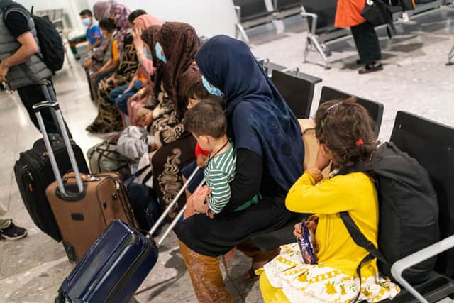Refugees from Afghanistan wait to be processed after arriving on a evacuation flight at Heathrow Airport on August 26. (Photo by Dominic Lipinski - WPA Pool/Getty Images)