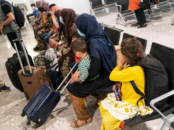 Refugees from Afghanistan wait to be processed after arriving on a evacuation flight at Heathrow Airport on August 26. (Photo by Dominic Lipinski - WPA Pool/Getty Images)