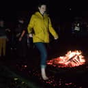 A woman takes part in the firewalk fundraising challenge to help the charity Katharine House Hospice (Image from Katharine House Hospice)