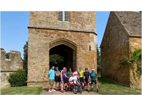 Andy Gill (kneeling) of new Banbury-based charity Dementia Active with members of the Kelly’s Heroes group who are cycling from Broughton Castle to Lands End to raise money for Dementia Active. (Photo from Martin Fiennes of Broughton Castle)