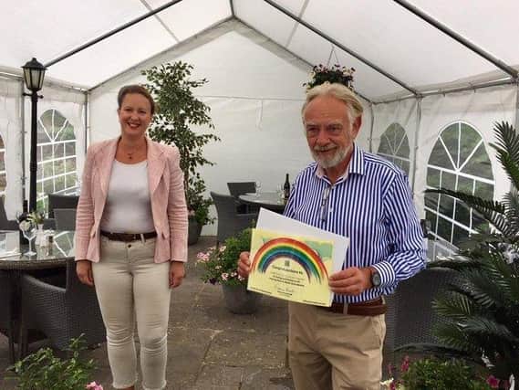 Banbury MP Victoria Prentis presents Trevor Brown, the owner of the Pickled Ploughman pub in Adderbury, with his unsung hero award in July 2020.