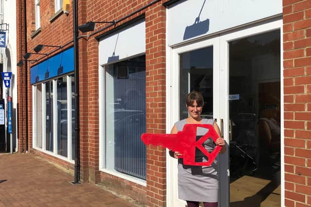 Heather Morison, head of operations & finance at Oxfordshire Youth, with the big red key outside the new unit in the town centre of Banbury (photo credit Makespace Oxford)
