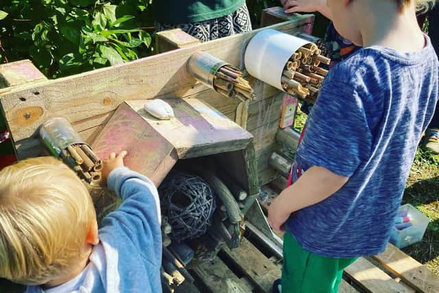 Children work on a bee hotel at an event held at the Bridge Street Garden in Banbury on Saturday September 18. (submitted photo)