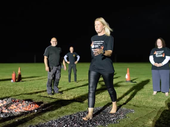 A woman takes part in the firewalking event to help Katharine House Hospice (photo by Neil Simmons with Modern Parlances Photos)