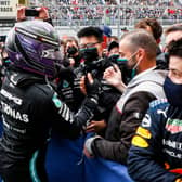 Lewis Hamilton celebrates with his Mercedes team after winning his 100th race