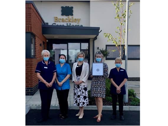 Photo: Care Home manager Sheena Croston proudly displays the carehome.co.uk certificate, surrounded by staff.
