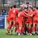 Ethan Johnston is mobbed by his Banbury United team-mates after he scored the dramatic late winner in Saturday's FA Cup tie at Basford United. Picture by Julie Hawkins