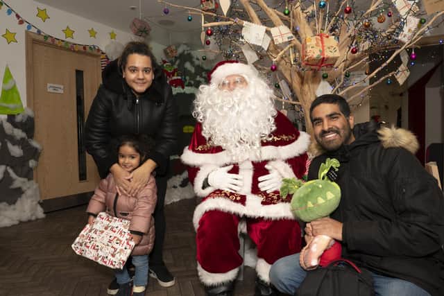 Santa met families at Ronald McDonald House on his Christmas visit to the JR Hospital. Here he meets patient Avani and her parents