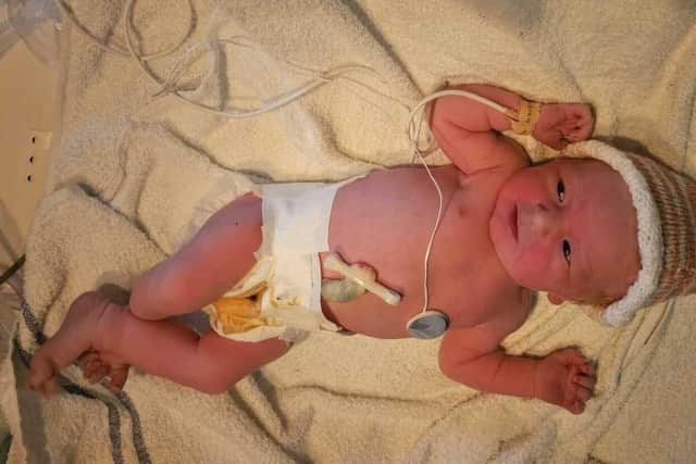 Baby Cleo Gray shortly after being delivered by her father, Matt