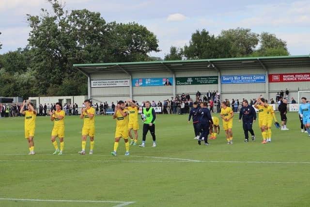 The Banbury players applaud the travelling fans after their victory at Darlington
