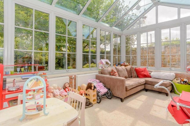 The conservatory has windows to two elevations and French doors opening out to a sun terrace.