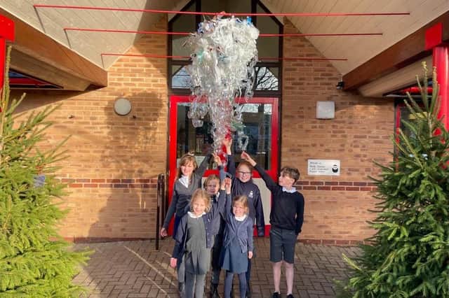 Hook Norton Primary School students with one of their art creations.