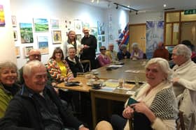 A meeting of SocialEyes at The Mill, Banbury. Janet Johnson (pictured at the back) receives the £500 Banbury Rotary Club cheque