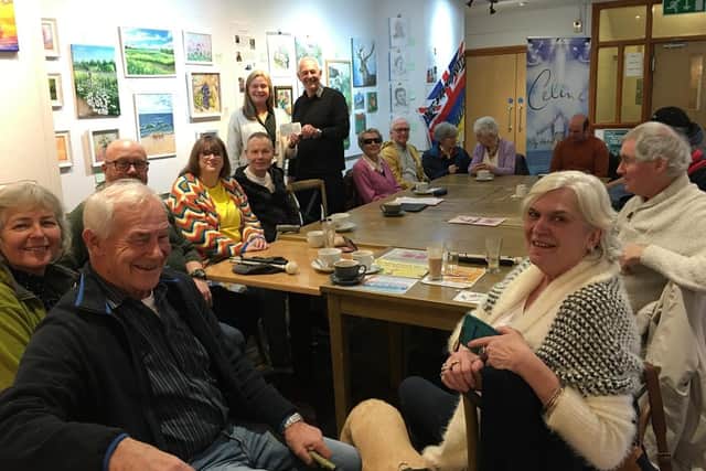 A meeting of SocialEyes at The Mill, Banbury. Janet Johnson (pictured at the back) receives the £500 Banbury Rotary Club cheque