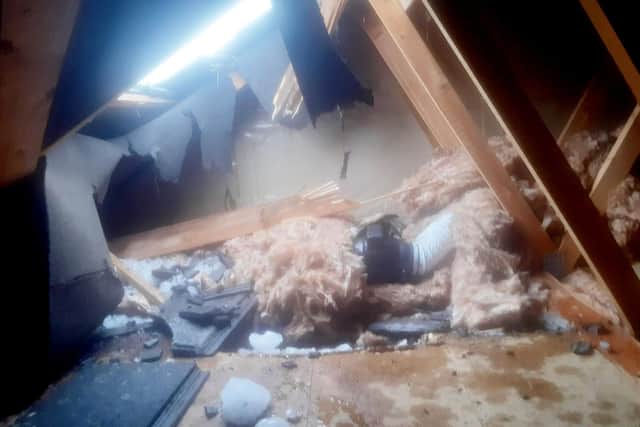 The attic pictured after a huge block of ice smashed the roof tiles after falling from a plane