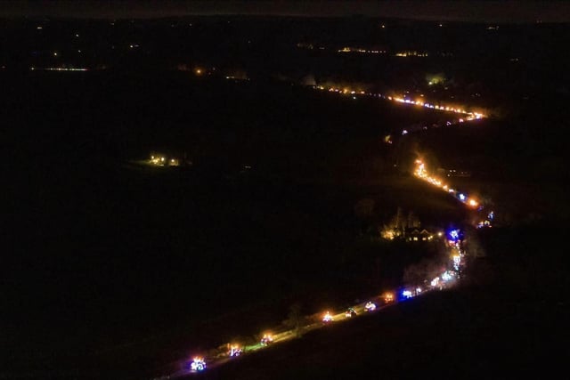 An incredible aerial shot of the brightly lit tractors passing through the Oxfordshire countryside.