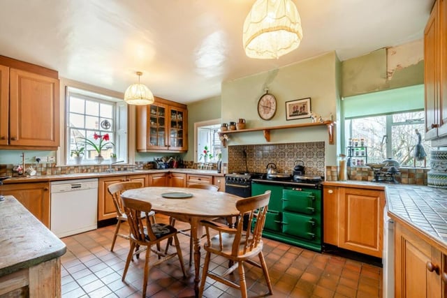 The kitchen has base and eye-level wooden fronted units, tiled work surfaces, stainless steel sink unit, plumbing facilities, built in dresser unit, oil-fired Aga with two hotplates.