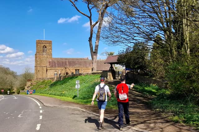 Ian Faulkner and Ryan Harris walk towards St Michael's Church in Warmington on the Edgehill Churches Good Friday walk on April 15