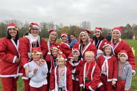 Dee Loader, second from left, ran the KHH Santa Fun Run last year with a group of friends and families, in memory of a dear friend who died at the hospice