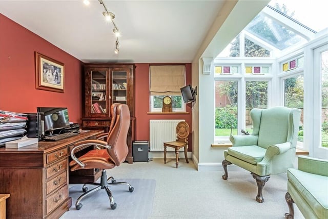 The conservatory is a comfortable light room with double doors leading to the garden.