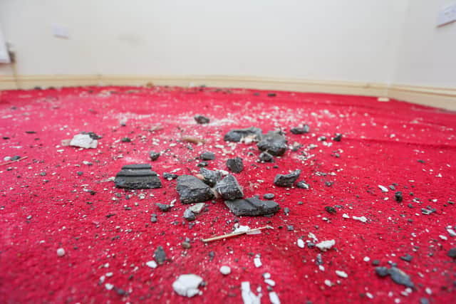 The impact of the ice on the roof caused broken tiles to fall to the floor of a bedroom