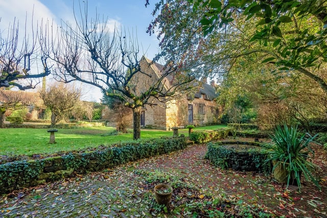 The house is surrounded by an orchard with mature fruit trees, a sunken garden with pond, herb garden and vegetable garden.