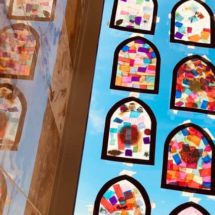Work created by Key Stage 1 and Key Stage 2 children using coloured tissue paper to create stained glass windows, displayed at the Banbury Mosque.