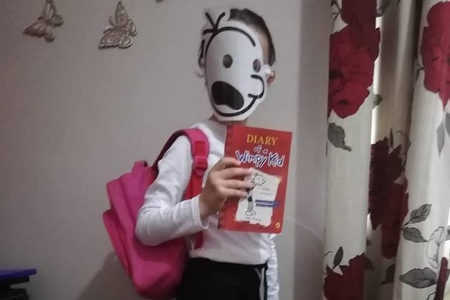 Isla Andre, aged 7, shows how easy it is to create the hero of Diary of a Wimpy Kid - dress a youngster in a white top, dark shorts and a backpack and head to the World Book Day website for a template to print off and make the mask. Simple!