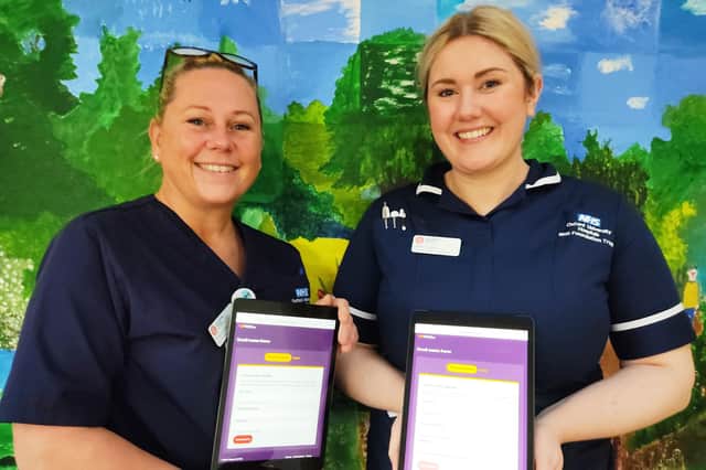 Katharine House Hospice deputy sister Tammy Smith and inpatient unit ward manager Abbie Hessey showing off the new iPads.